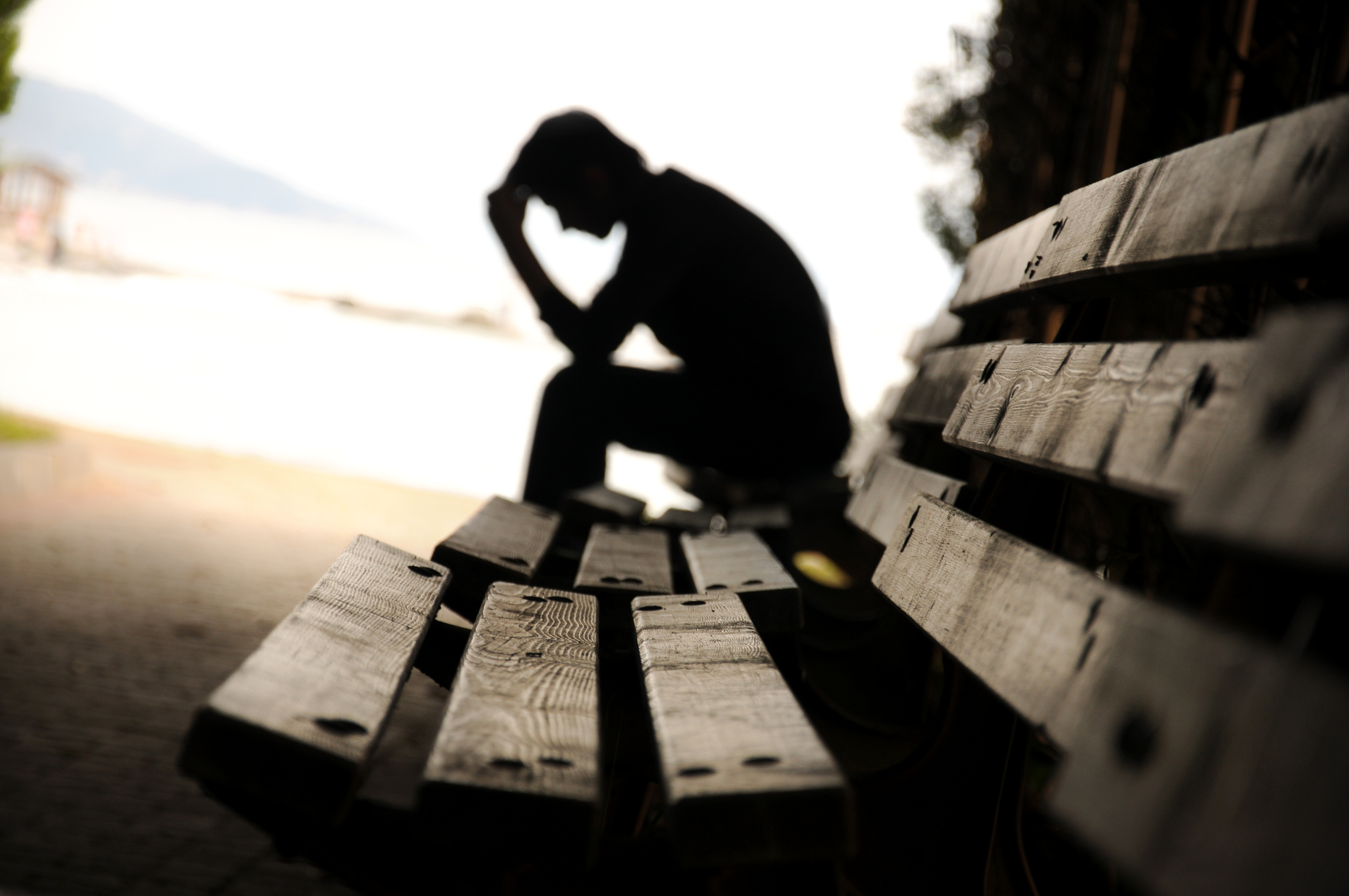 Suffering Man on a Park Bench