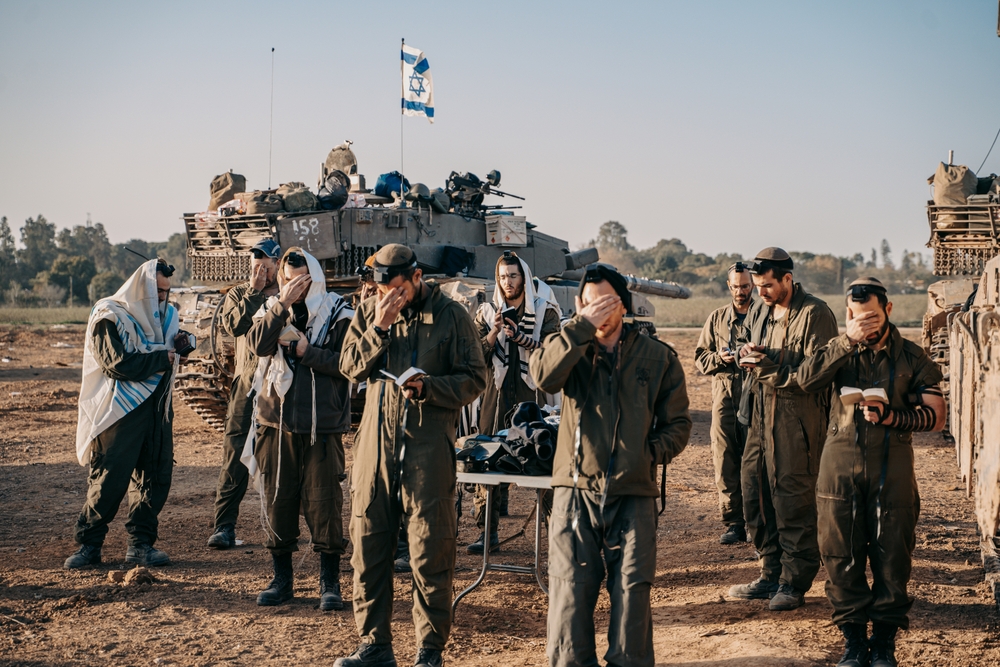 Coping with tragedy - Israel Gaza war - soldiers in prayer