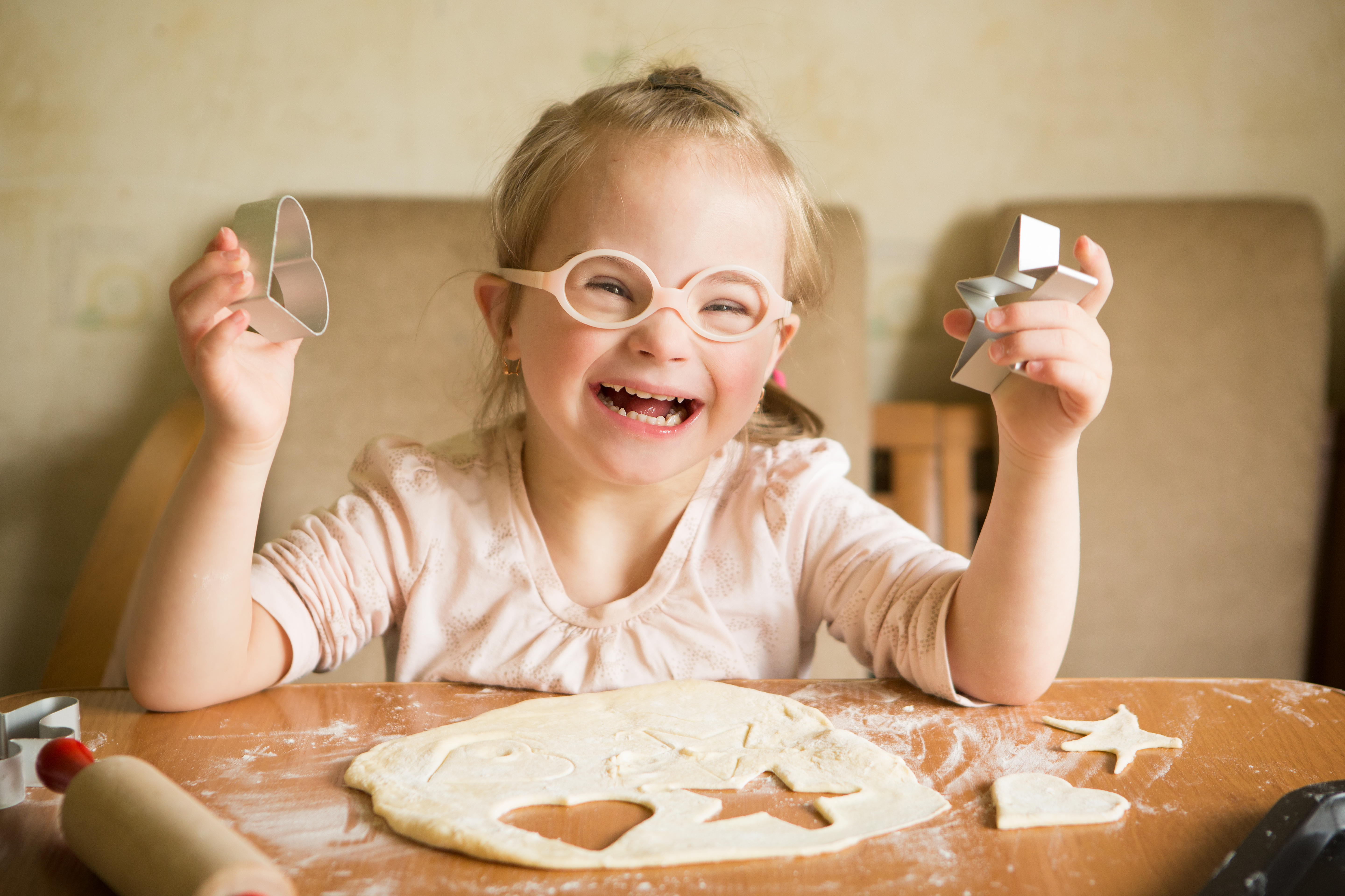 happy girl with downs syndrome baking cookies